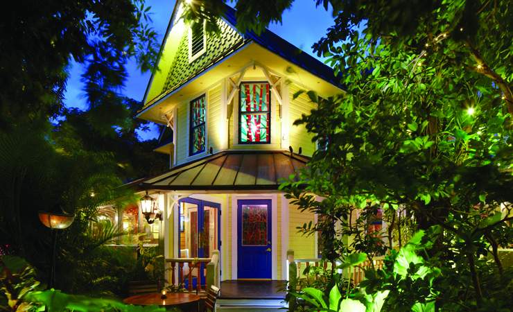 Side angle of nighttime view of house with lights